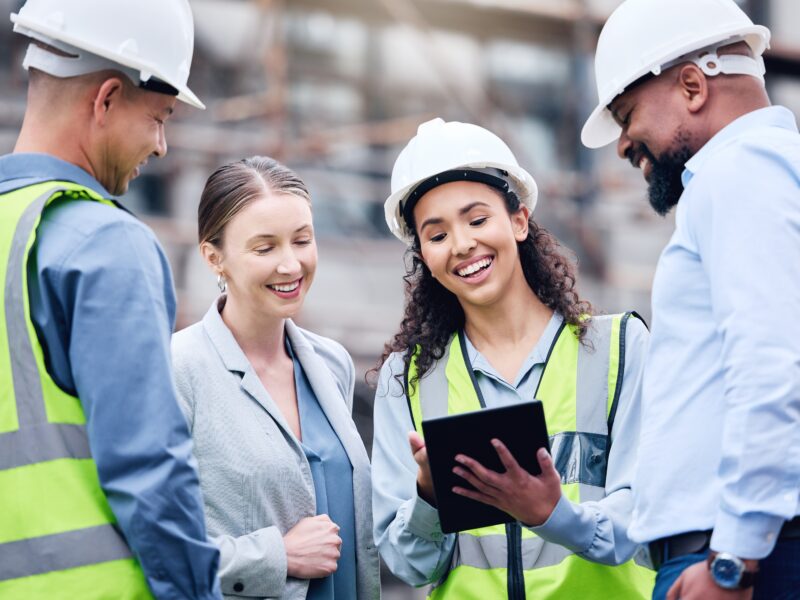 Construction,,Building,And,Group,With,Architect,On,Tablet,,Project,Blueprint